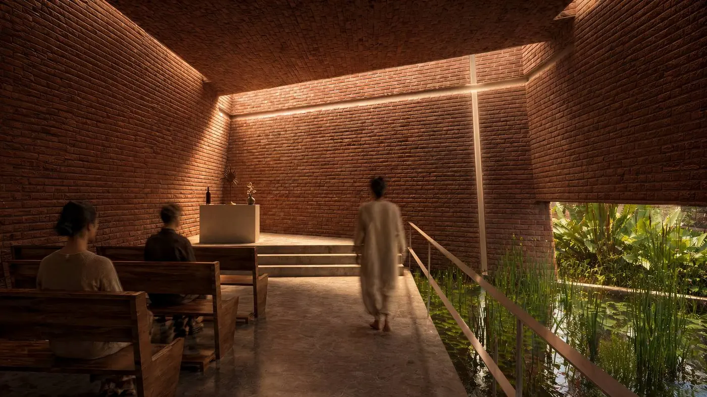 Capilla de ladrillo con luz cenital y estanque